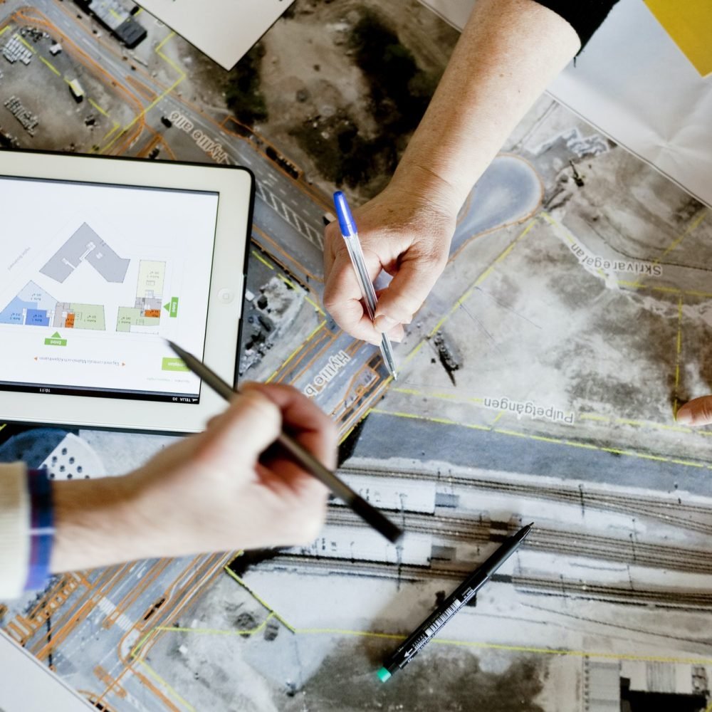 cropped-image-of-man-with-pens-discussing-over-street-map.jpg